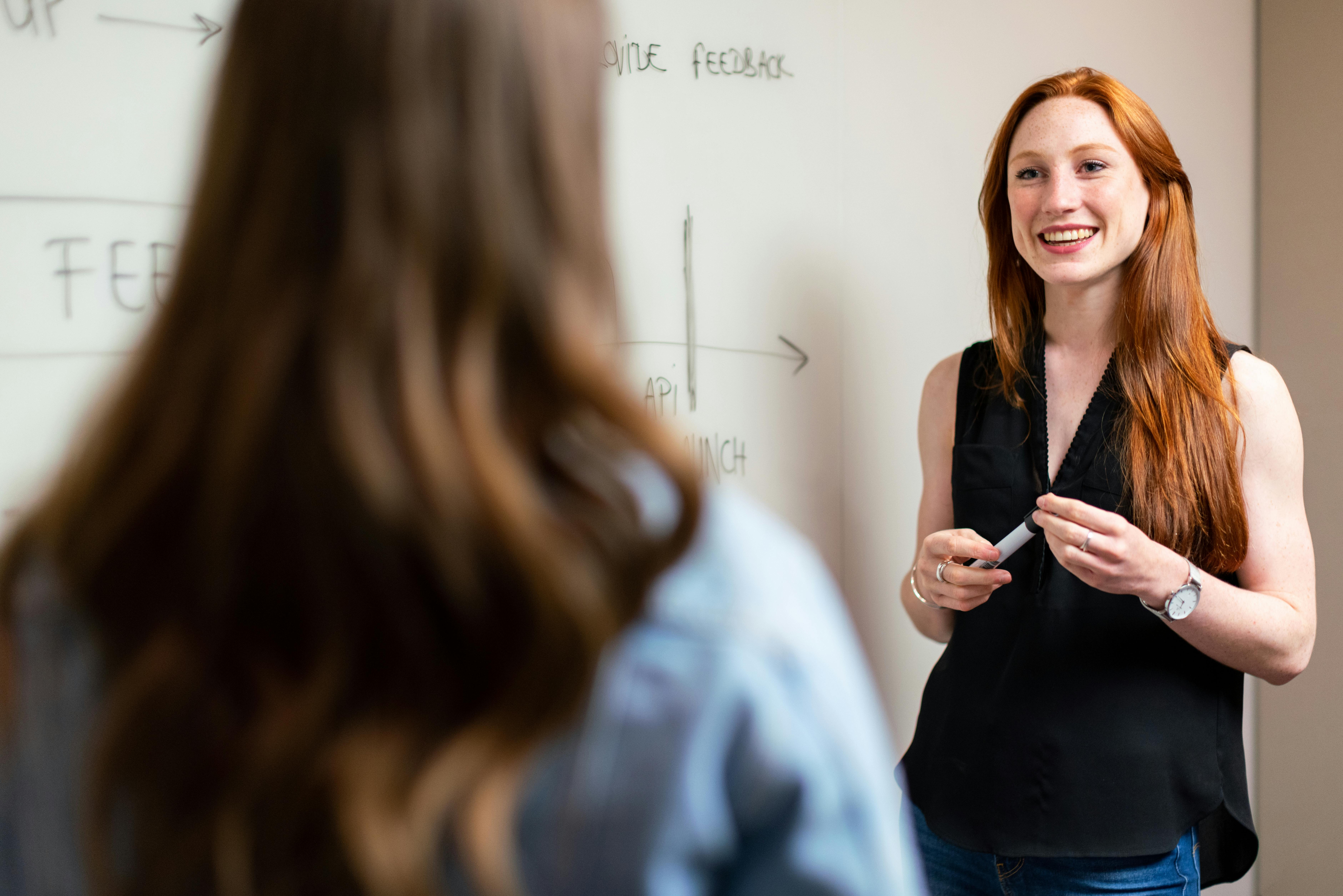 Lady in front of whiteboard