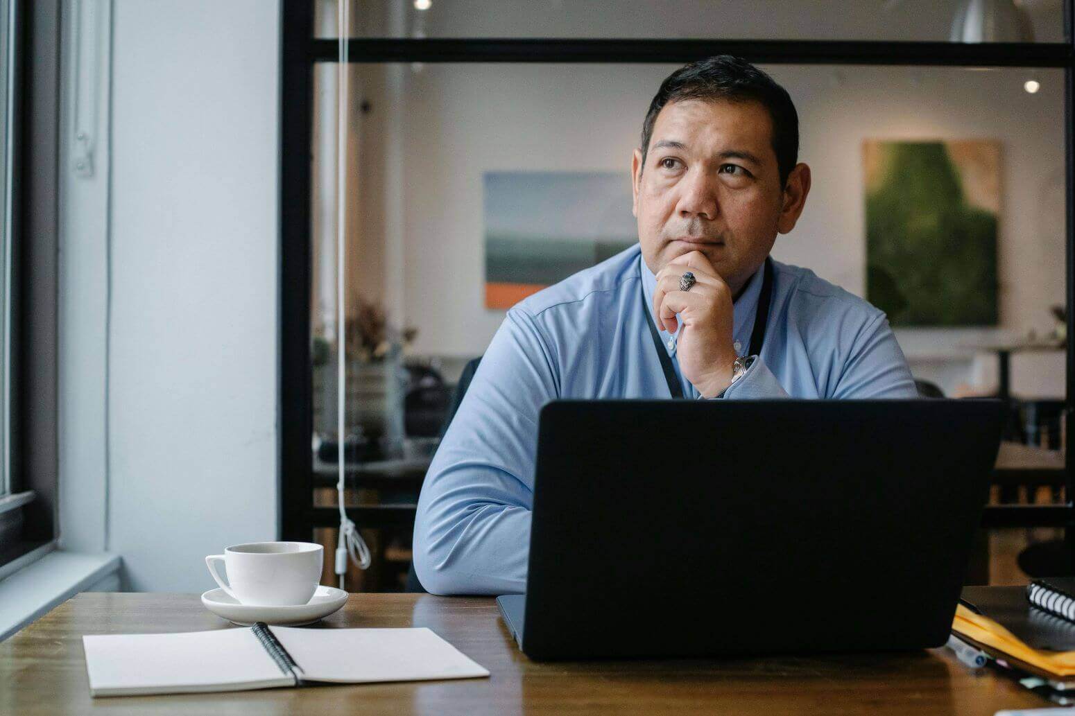 Man thinking with laptop
