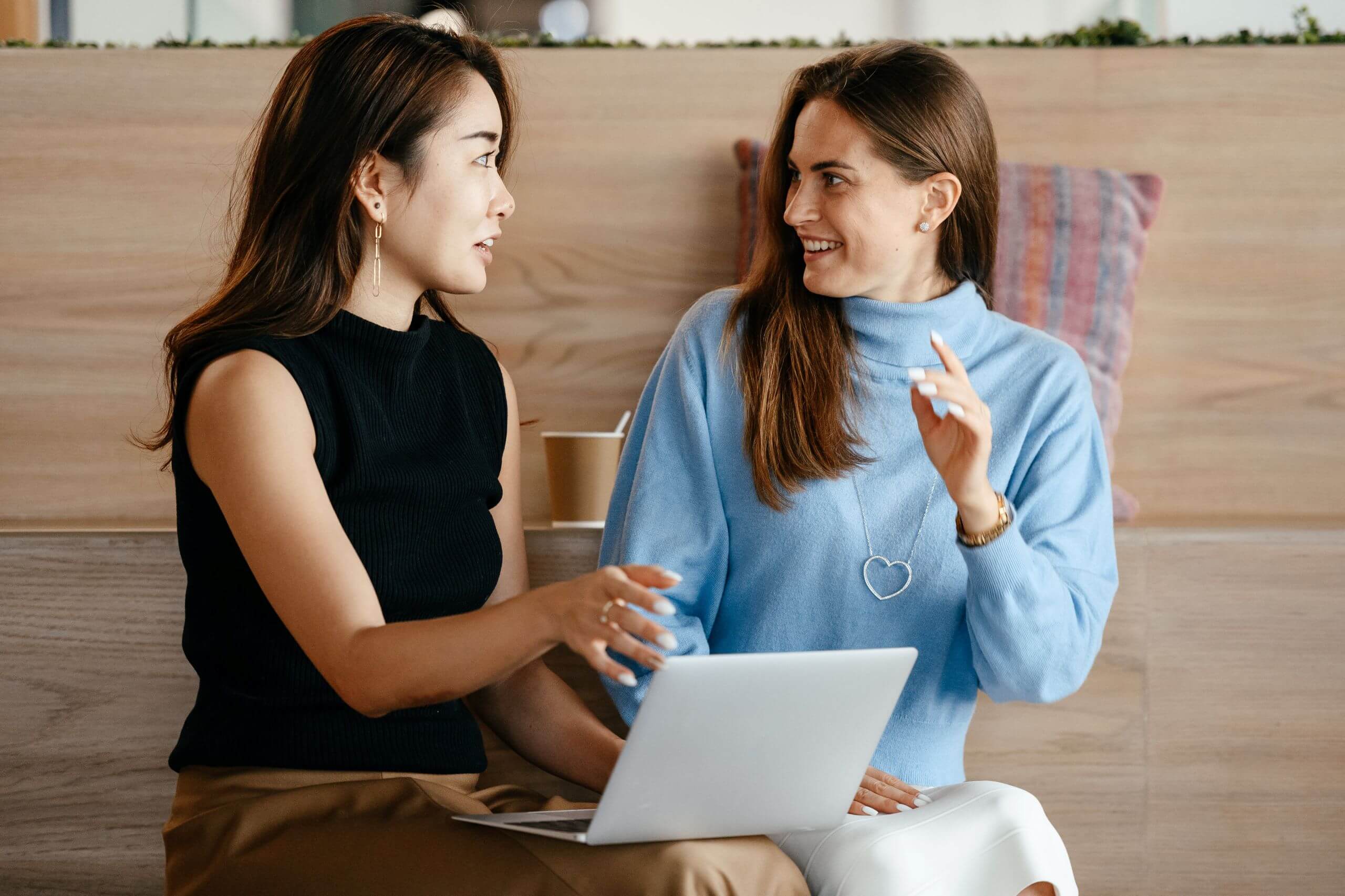 Two women looking at a laptop