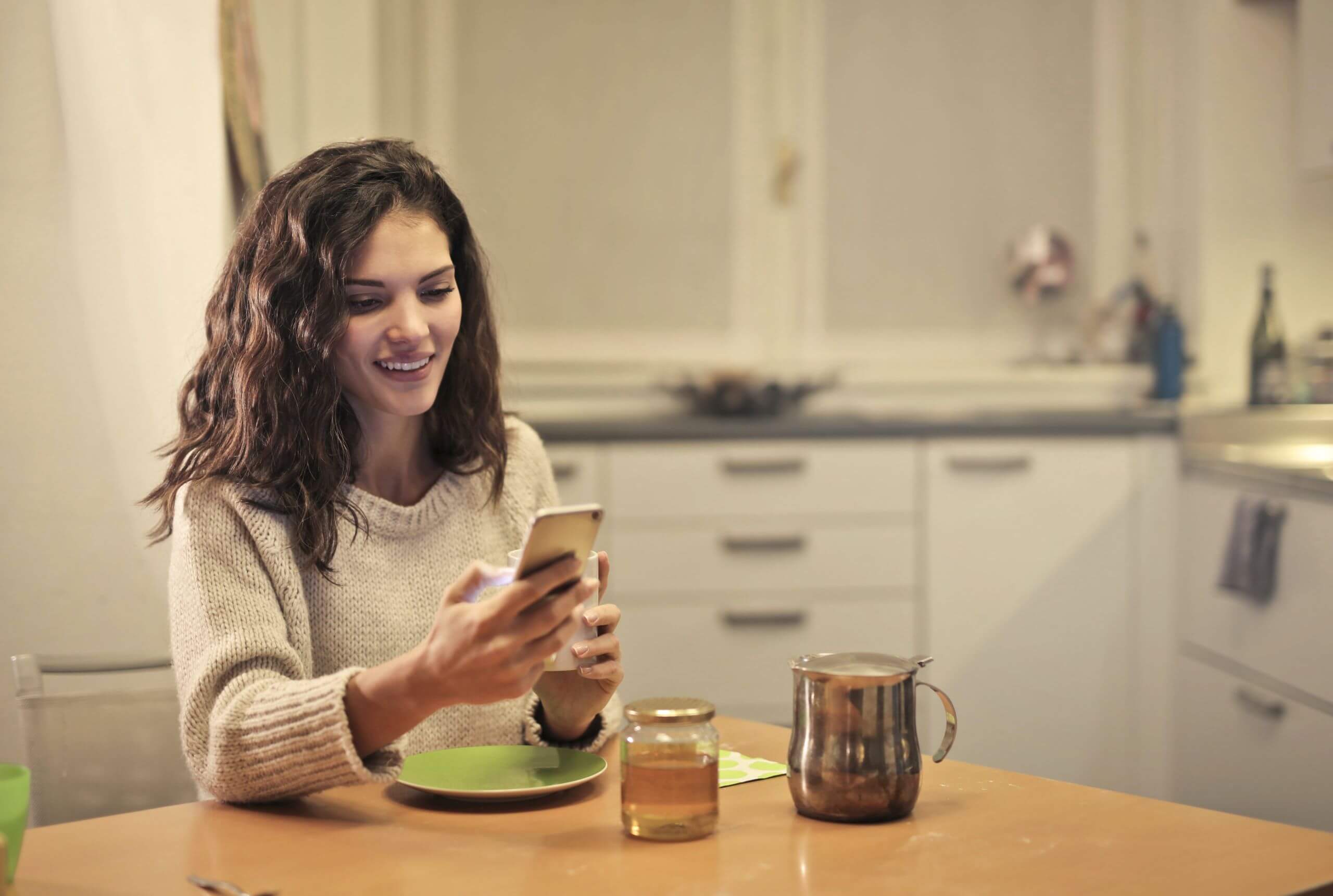 Young woman sitting at kitchen table